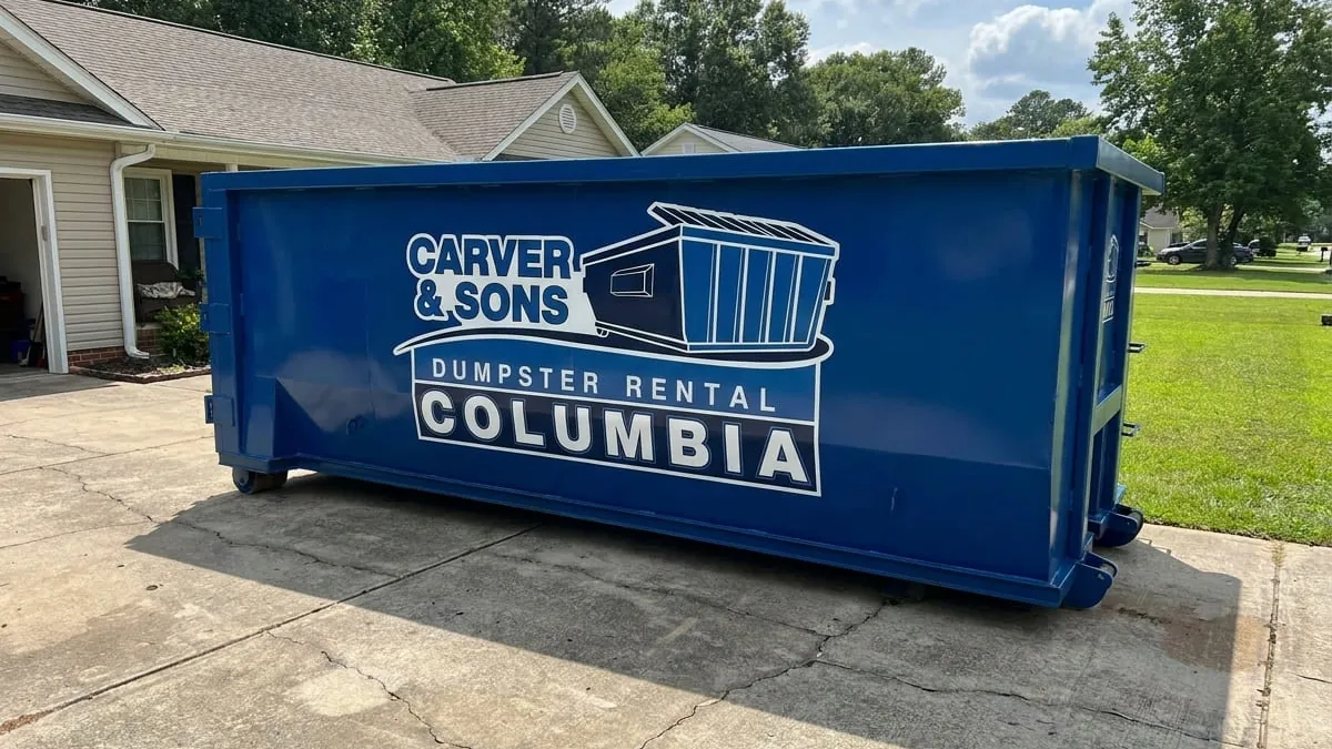 Carver & Sons Dumpster Rental crew standing with a roll-off truck and 30 yard dumpster in a Columbia, SC driveway Carver & Sons Dumpster Rental crew standing with a roll-off truck and 30 yard dumpster in a Columbia, SC driveway